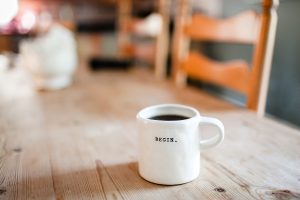Coffee mug with word "begin"